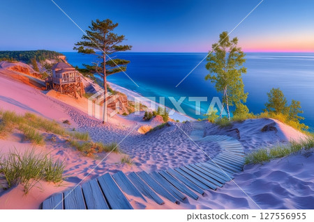 The Pierce Stocking Scenic Drive in Michigan features a summer sunset over Lake Michigan, with massive sand dunes and a scenic overlook within the Sleeping Bear Dunes National Lakeshore 127556955
