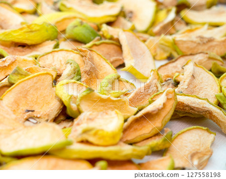 Dried apple pieces. 127558198