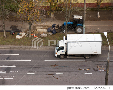 Road repair. Tractor. Workers. Road repair. Tractor. Workers. 127558207
