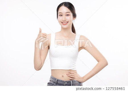 Portrait of young Asian beautiful woman with K-beauty make up style and healthy and perfect skin shows thumb up isolated on white background. Portrait of young Asian beautiful woman with K-beauty make up style and healthy and perfect skin shows thumb up isolated on white background. 127558461
