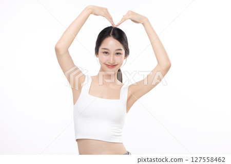 Beautiful Asian woman feels happy and makes romantic hand sign heart shape isolated on white background. People affection and care concept Beautiful Asian woman feels happy and makes romantic hand sign heart shape isolated on white background. People affection and care concept 127558462