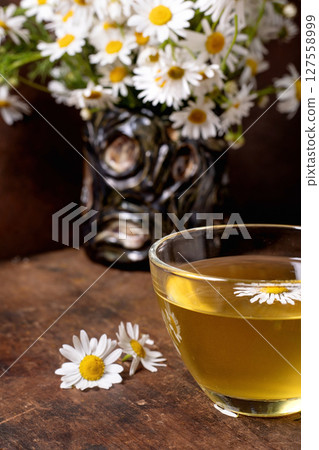 Chamomile Tea Cup with Fresh Daisy Flowers Chamomile Tea Cup with Fresh Daisy Flowers 127558999