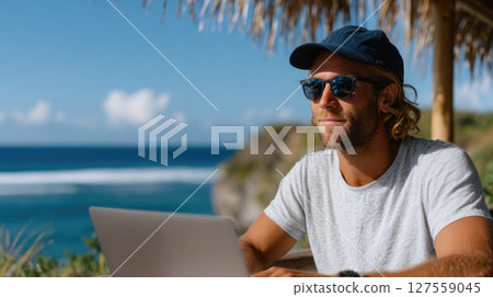 Man Working Remotely at Beachside with Laptop Man Working Remotely at Beachside with Laptop 127559045