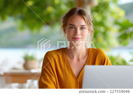 Woman Working Remotely in a Tropical Setting Woman Working Remotely in a Tropical Setting 127559046