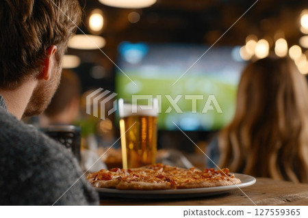 Watching Live Sports Game with Beer and Pizza at Cozy Bar 127559365