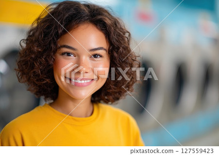 Girl in Yellow Shirt Smiling Indoors 127559423