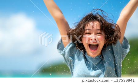 Excited Girl Jumping with Arms Raised on the Beach Excited Girl Jumping with Arms Raised on the Beach 127559941