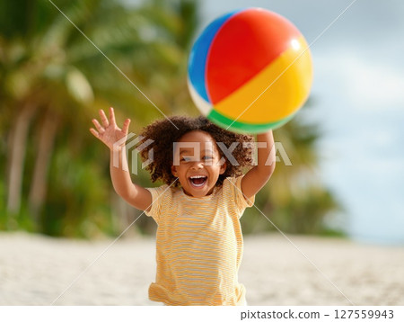 Child Playing with Beach Ball in Tropical Setting Child Playing with Beach Ball in Tropical Setting 127559943