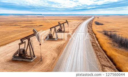 Oil Pump Jacks in Dry Prairie Landscape 127560044
