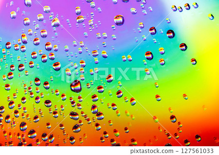 Water drops of different sizes close-up macro on rainbow sparkly mirror polished surface Water drops of different sizes close-up macro on rainbow sparkly mirror polished surface 127561033
