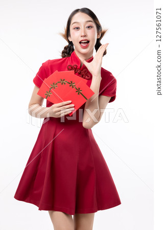 Portrait of joyful beauty Asian woman in red Cheongsam Chinese traditional dress celebrating with lucky red envelopes on Chinese New Year festival isolated on white background. 127561071
