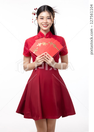 Portrait of joyful beauty Asian woman in red Cheongsam Chinese traditional dress celebrating with lucky red envelopes on Chinese New Year festival isolated on white background. 127561104
