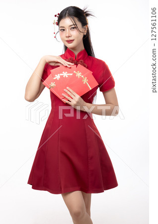Portrait of joyful beauty Asian woman in red Cheongsam Chinese traditional dress celebrating with lucky red envelopes on Chinese New Year festival isolated on white background. 127561106