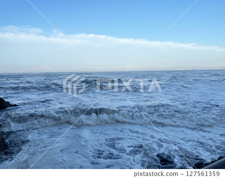 Sea waves rocky beach 127561359
