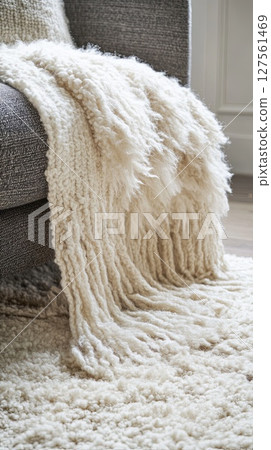 shaggy rug topped by chunky knit throw. shaggy rug topped by chunky knit throw. 127561469