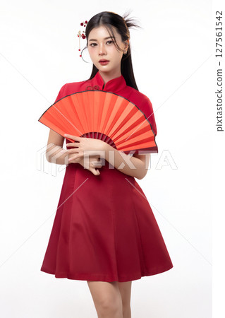 Portrait of joyful beauty Asian woman in red Cheongsam Chinese traditional dress holding red fan isolated on white background for Chinese New Year festival content. 127561542