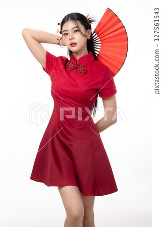 Portrait of joyful beauty Asian woman in red Cheongsam Chinese traditional dress holding red fan isolated on white background for Chinese New Year festival content. 127561543