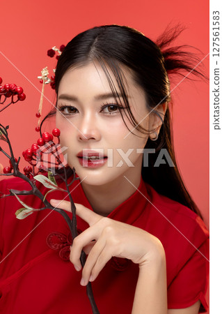 Portrait of beauty Asian woman in red Cheongsam Chinese traditional dress isolated on red background. 127561583