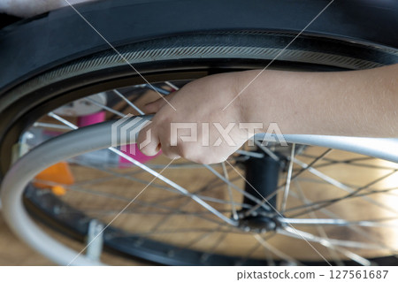 Top view of the arm of a child in a wheelchair. The concept of mobility problems. 127561687