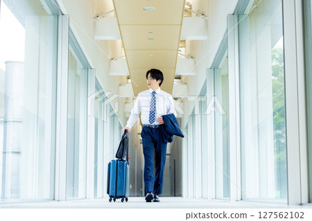 A young man walking with a carry bag A young man walking with a carry bag 127562102