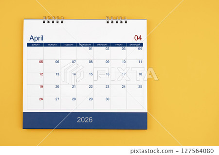 April 2026 desk calendar on the yellow table, planning for business meeting or planning concept. April 2026 desk calendar on the yellow table, planning for business meeting or planning concept. 127564080