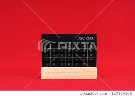 July 2026 chalkboard calendar on red color background. July 2026 chalkboard calendar on red color background. 127564109