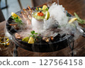 Grilled seafood platter with mussels, shrimp, octopus, and seared tuna. Served with fresh herbs, lemon wedges, and creamy avocado sauce with caviar. Exquisite gourmet dish in a fine dining restaurant 127564158