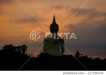 The largest golden Buddha statue with green rice field foreground at Wat Muang Temple in Ang Thong Province, Thailand. 127566242