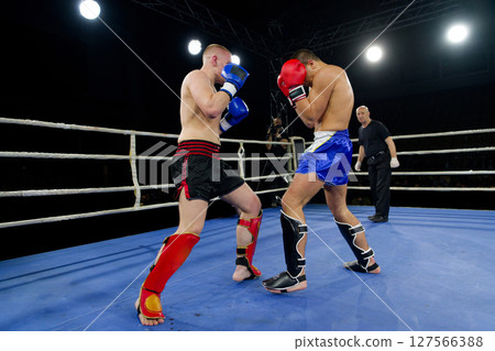 Fierce boxing match showcases athletes' power and skill. 127566388