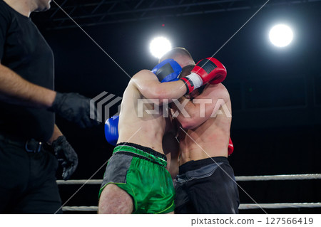 Fierce boxing match showcases athletes' power and skill. 127566419