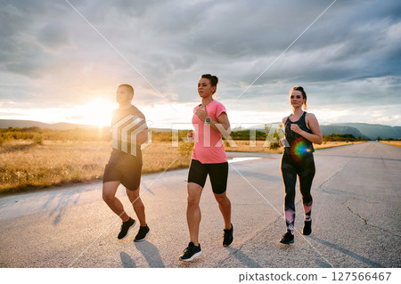 Athlete Leading Group Run at Sunset Amidst Stunning Nature 127566467