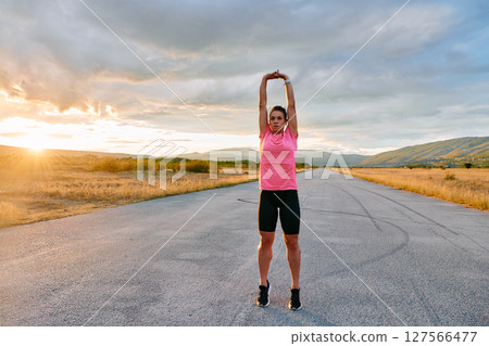 Athlete Stretching at Sunset After Intense Run Athlete Stretching at Sunset After Intense Run 127566477