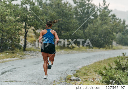 Unstoppable: A Determined Athlete Trains Through the Rain in Pursuit of Marathon Glory 127566497