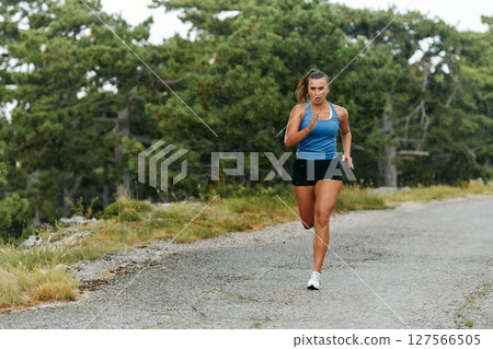 Unstoppable: A Determined Athlete Trains Through the Rain in Pursuit of Marathon Glory 127566505
