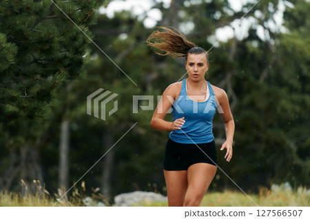 Unstoppable: A Determined Athlete Trains Through the Rain in Pursuit of Marathon Glory 127566507