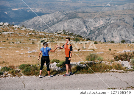 Joyful Couple Celebrating the Successful Completion of a Morning Run. 127566549