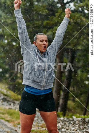 Beautiful Woman Enjoying Rainy Day After Intense Run 127566679