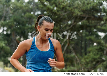 Unstoppable: A Determined Athlete Trains Through the Rain in Pursuit of Marathon Glory 127566702