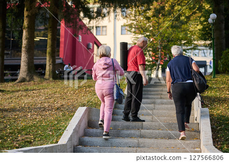 A group of senior friends takes a well-deserved break in nature, fostering not only fitness but also camaraderie and a shared commitment to maintaining a healthy and active lifestyle in their golden A group of senior friends takes a well-deserved break in nature, fostering not only fitness but also camaraderie and a shared commitment to maintaining a healthy and active lifestyle in their golden 127566806