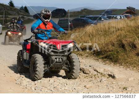 Man driving modern quad bike on sandy road. Extreme sport 127566837