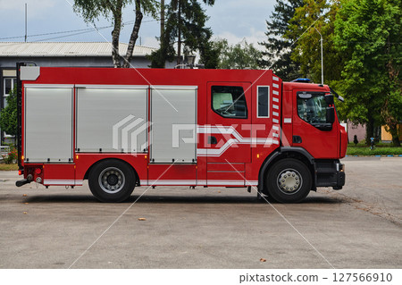 A state-of-the-art firetruck, equipped with advanced rescue technology, stands ready with its skilled firefighting team, prepared to intervene and respond rapidly to emergencies, ensuring the safety A state-of-the-art firetruck, equipped with advanced rescue technology, stands ready with its skilled firefighting team, prepared to intervene and respond rapidly to emergencies, ensuring the safety 127566910