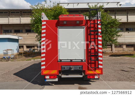 A state-of-the-art firetruck, equipped with advanced rescue technology, stands ready with its skilled firefighting team, prepared to intervene and respond rapidly to emergencies, ensuring the safety 127566912