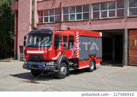 A state-of-the-art firetruck, equipped with advanced rescue technology, stands ready with its skilled firefighting team, prepared to intervene and respond rapidly to emergencies, ensuring the safety 127566918