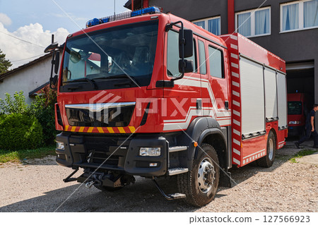 A state-of-the-art firetruck, equipped with advanced rescue technology, stands ready with its skilled firefighting team, prepared to intervene and respond rapidly to emergencies, ensuring the safety 127566923