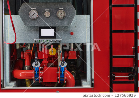 Close-up of essential firefighting equipment on a modern firetruck, showcasing tools and gear ready for emergency response to hazardous fire situations Close-up of essential firefighting equipment on a modern firetruck, showcasing tools and gear ready for emergency response to hazardous fire situations 127566929