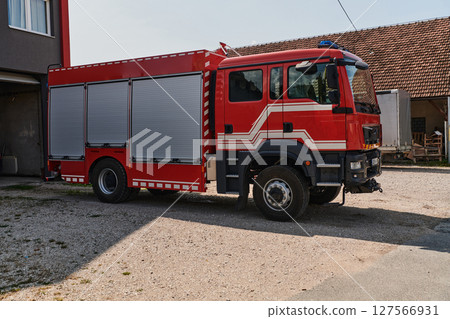 A state-of-the-art firetruck, equipped with advanced rescue technology, stands ready with its skilled firefighting team, prepared to intervene and respond rapidly to emergencies, ensuring the safety 127566931