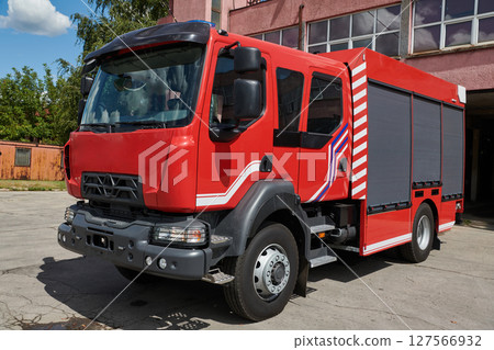 A state-of-the-art firetruck, equipped with advanced rescue technology, stands ready with its skilled firefighting team, prepared to intervene and respond rapidly to emergencies, ensuring the safety 127566932