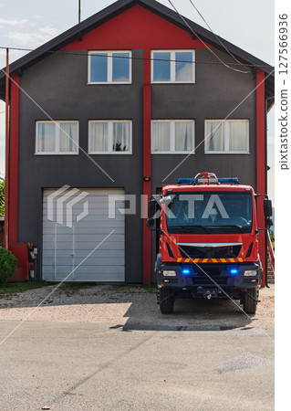 A state-of-the-art firetruck, equipped with advanced rescue technology, stands ready with its skilled firefighting team, prepared to intervene and respond rapidly to emergencies, ensuring the safety A state-of-the-art firetruck, equipped with advanced rescue technology, stands ready with its skilled firefighting team, prepared to intervene and respond rapidly to emergencies, ensuring the safety 127566936