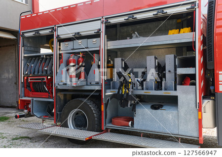Close-up of essential firefighting equipment on a modern firetruck, showcasing tools and gear ready for emergency response to hazardous fire situations Close-up of essential firefighting equipment on a modern firetruck, showcasing tools and gear ready for emergency response to hazardous fire situations 127566947