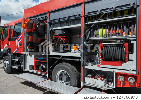 A state-of-the-art firetruck, equipped with advanced rescue technology, stands ready with its skilled firefighting team, prepared to intervene and respond rapidly to emergencies, ensuring the safety 127566978